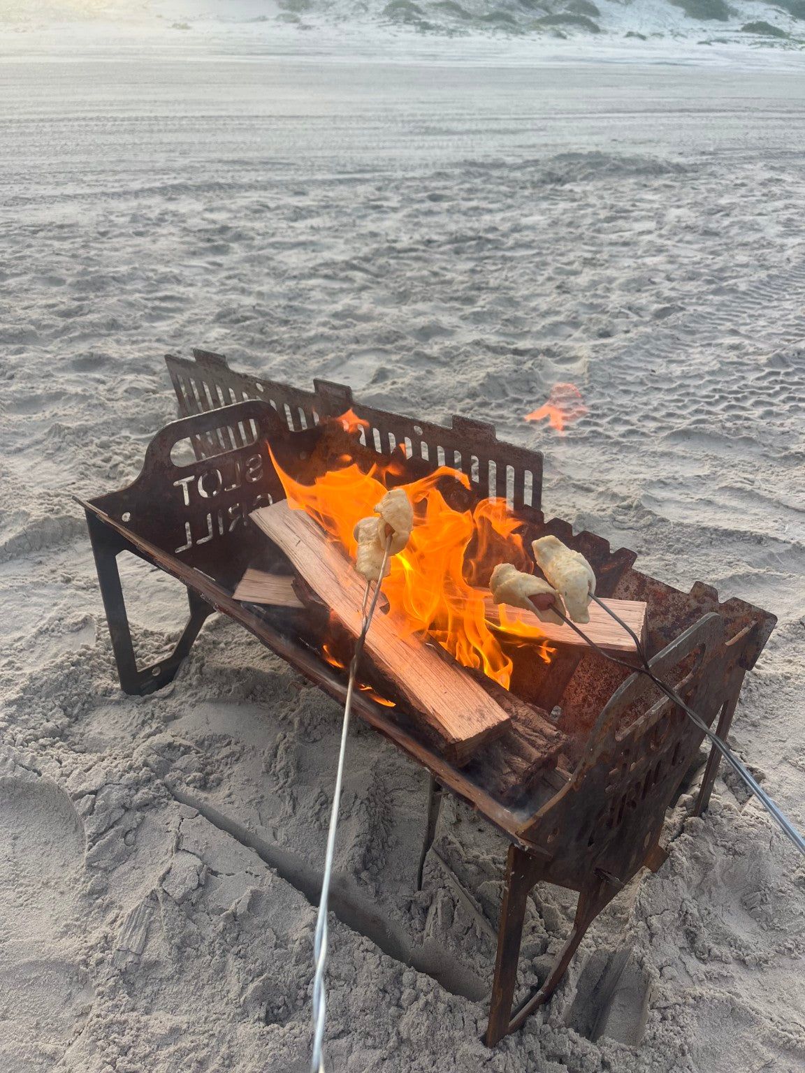 Customer using a Slot Grill as a beach fire pit