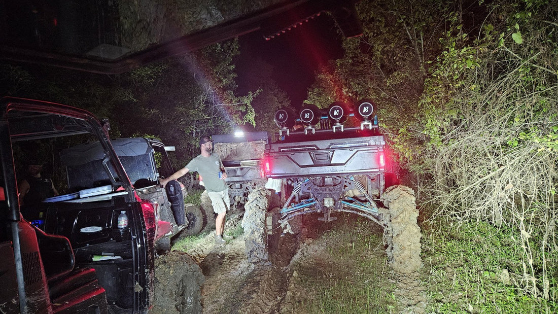 Muddy side-by-sides gathered on a night trail ride