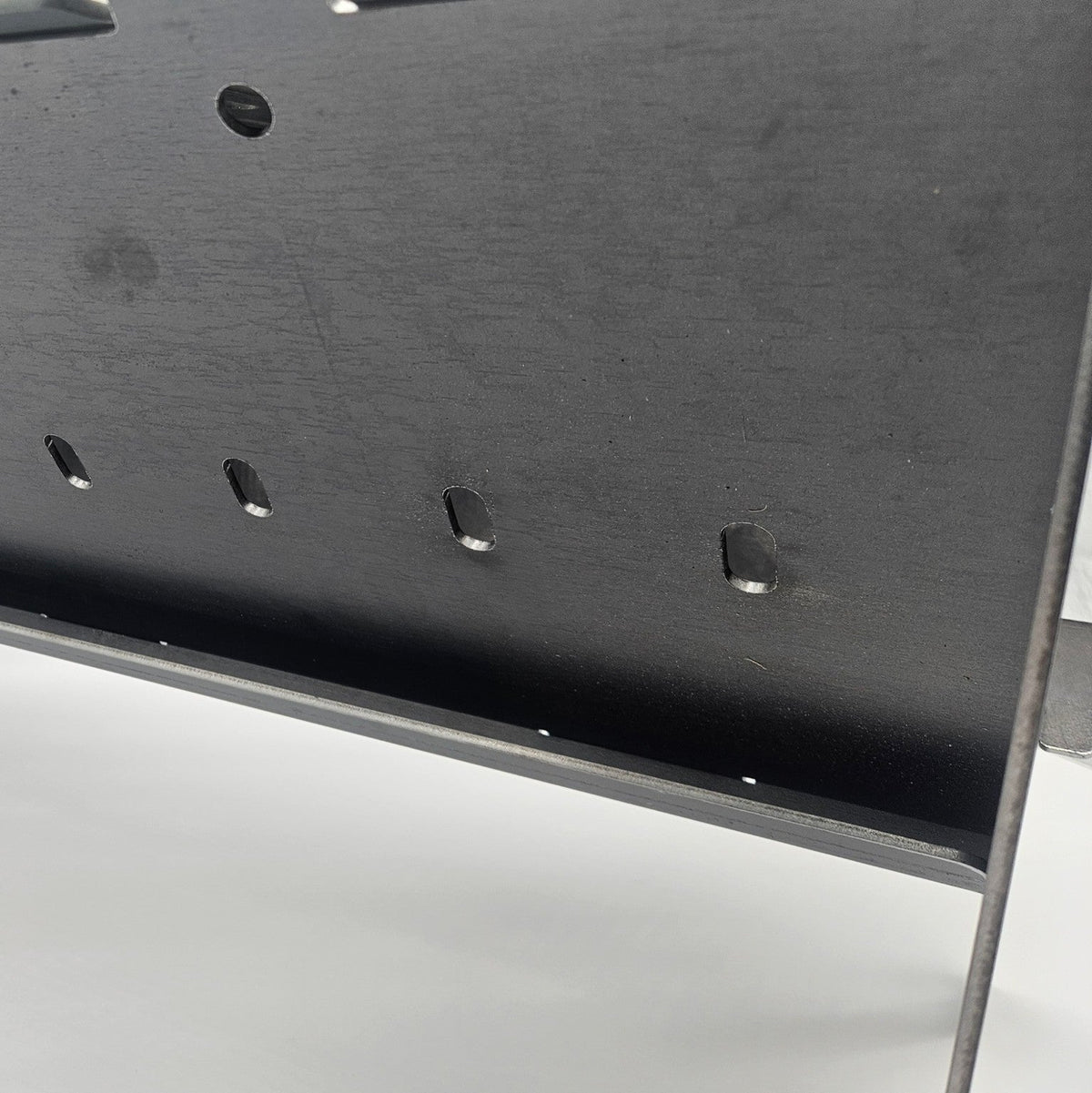 Close-up of Slot Grill carbon steel firebox and vent holes