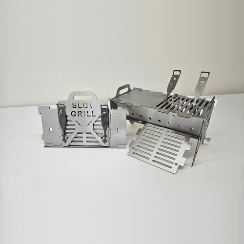 Slot Grill Compact assembled with a griddle plate and grate, next to its flat-packed panels