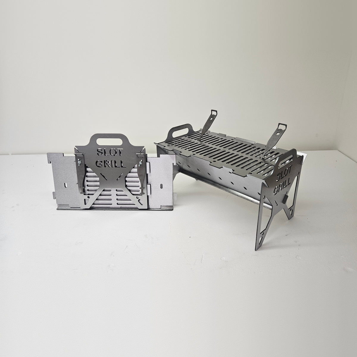 Slot Grill Full Size assembled with slotted grill grates, next to its flat-packed panels
