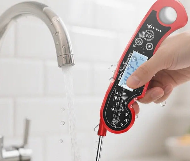 Rinsing the Slot Grill digital meat thermometer under running water
